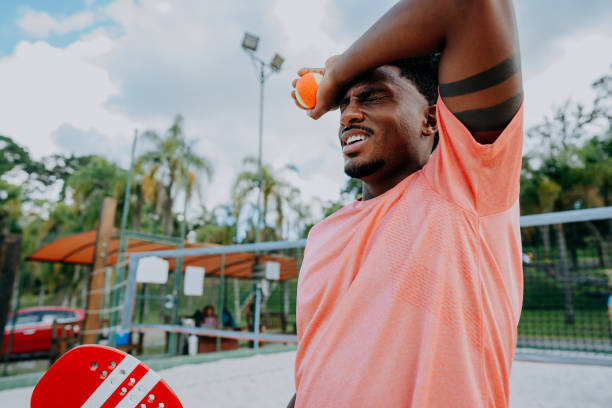 istock Man playing beach tennis tired sweaty 1465896831