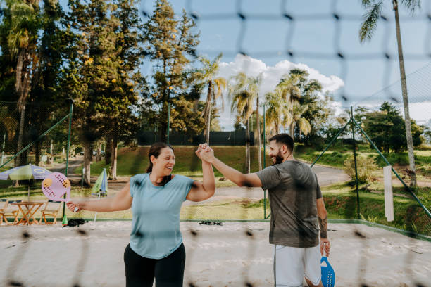 istock Couple playing beach tennis 1465897238