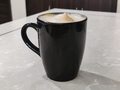 Black Coffee Mug. Hot and Frothy Cappuccino