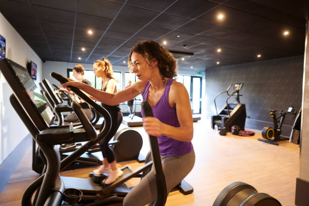 istock cross trainer women at the gym 1465908835