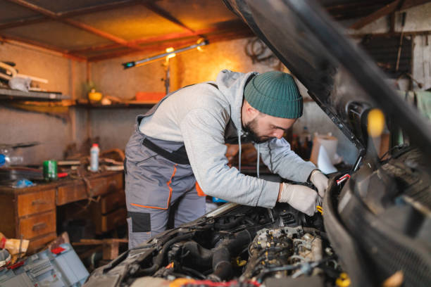 istock Young male mechanic working on a broken car in his garage 1465911182