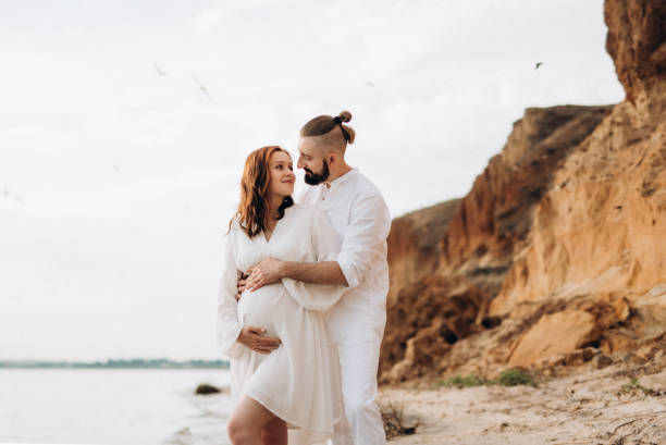 istock a guy with a girl in white clothes on the seashore 1465915600