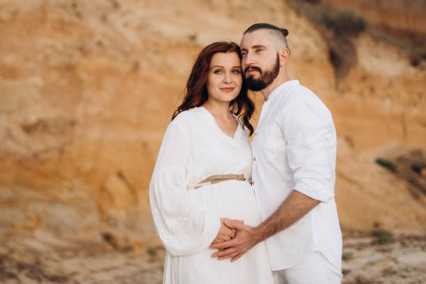 istock a guy with a girl in white clothes on the seashore 1465916192