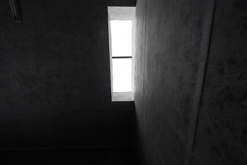 A corner of ceiling wall of gray concrete building