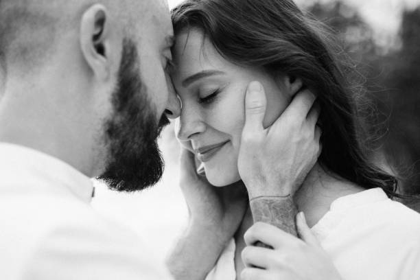 istock a guy with a girl in white clothes on the seashore 1465921309