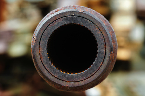 A big gun. The rifled gun of the tank. Close-up of a tank gun barrel with rifling. Abstract background of the armed conflict.
