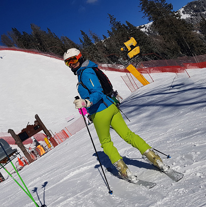 Mid age caucasian woman getting ready for a fun ride in a ski center Madonna di Campiglio in Italy on a sunny winter day