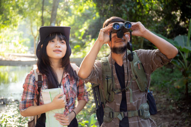 istock Family with father and daughter tourist backpack hiking doing activity while father looking binoculars in holiday together, man and teenager woman journey adventure trip and looking map. 1465924608
