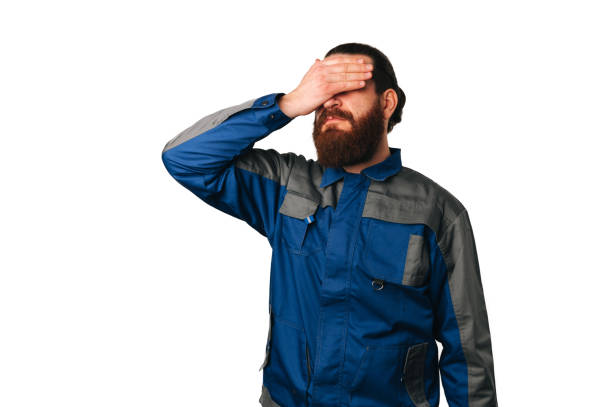 istock Disappointed man wearing handyman uniform is  and makes facepalm gesture. 1465925763