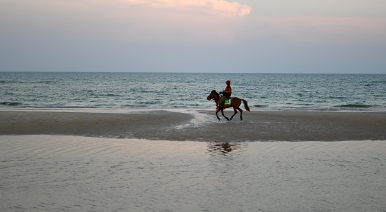 The man on the horse.\nThis photo was taken in the early evening of February 14, 2023 on the beach in Hua Hin, Thailand.