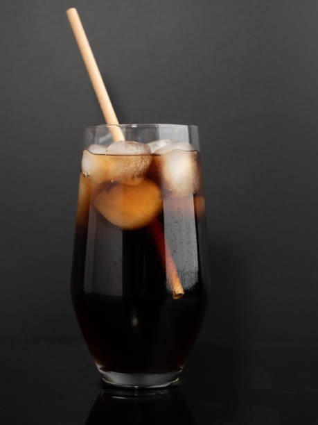 istock Glass of cola with ice on a black background. 1465928712