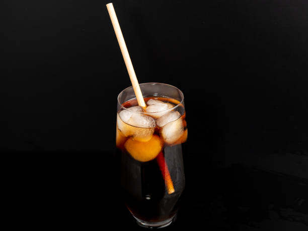 istock Glass of cola with ice on a black background. 1465929186