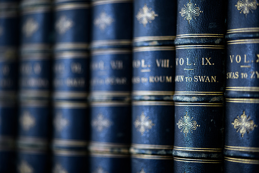 Antique 19th century books in bookshelf