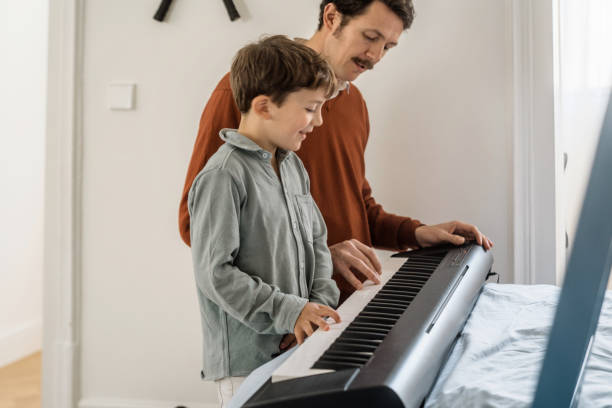 istock Father and son playing piano 1465932866