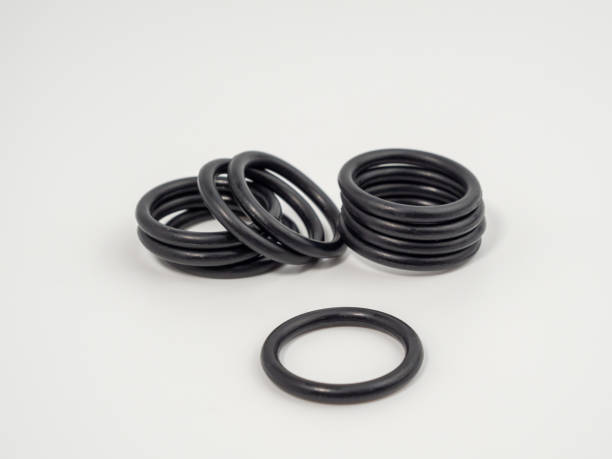 Hydraulic and pneumatic o-rings in black in different sizes on a white background. Rubber gaskets for plumbing.
