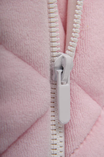 istock White fastener on soft pink warm baby overalls. 1465934034