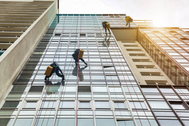 istock Industrial mountaineer laborers hangs on wall cityscape building 1465938018