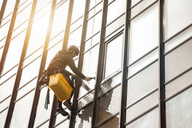 istock Industrial mountaineering worker hangs on facade skyscraper building 1465938126