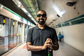 Portrait of a blind man at a subway station