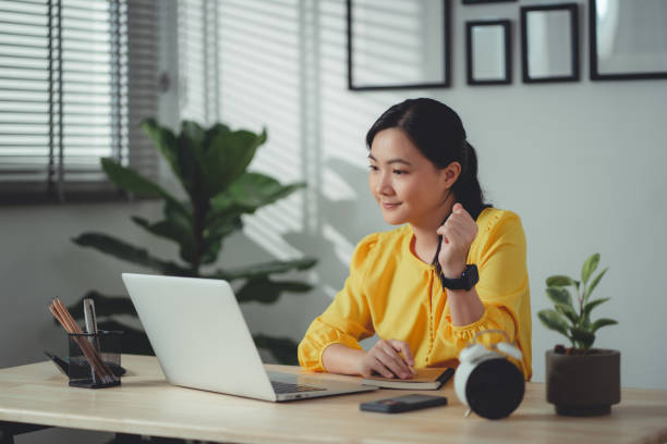istock Asian woman enjoy with working online using laptop talking on video conference at home office. 1465942019