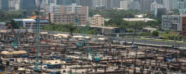 istock Large construction site with heavy construction machinery in metropolis captured during the early stage of mega construction project . 1465943828
