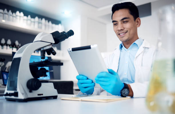 istock Science, tablet and microscope with a man at work in a laboratory for research or innovation. Doctor, medicine and healthcare with a male engineer working in a lab for future medical development 1465943870