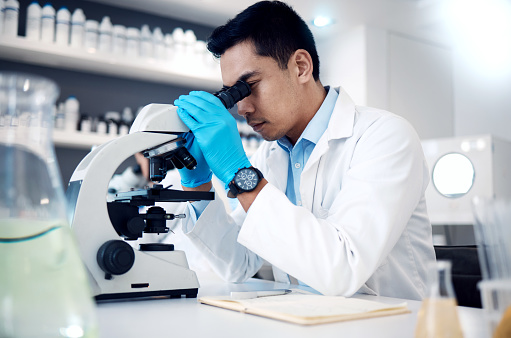 Microscope, Asian man and in laboratory for healthcare, science method and research innovation. Male researcher, chemist and medical professional check sample, results and lab equipment for analysis.