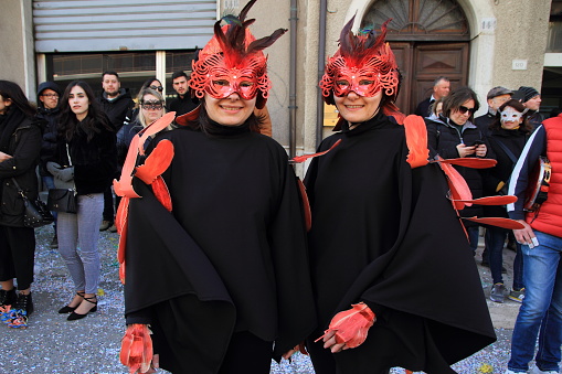 Venice, VE, Italy - February 13, 2024: Venetian mask in gold and red color at carnival