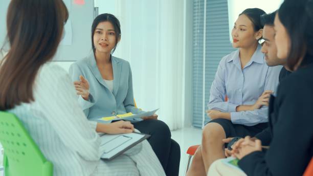 istock Business people proficiently discuss work project while sitting in circle . Corporate business team collaboration concept . 1465945994