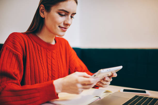 istock Smiling multitask female teleworker working remotely in cafe 1465947053