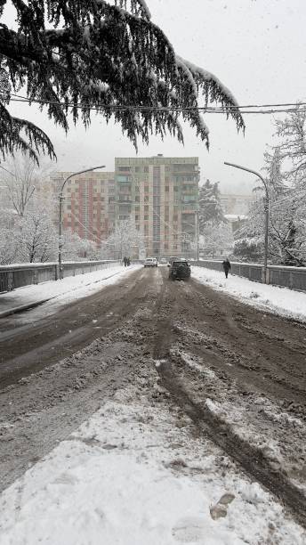 istock Snowy town road and bridge 1465947177