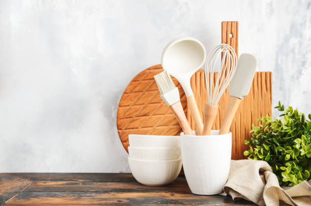 istock Background with kitchen utensils standing on wooden countertop. 1465948531