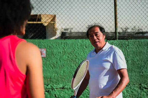 Coach talking to female tennis player