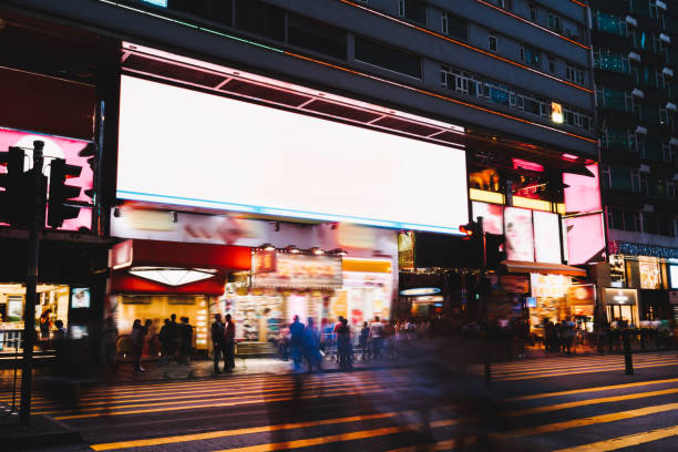 istock Crowded street with glowing billboard in night city 1465951959