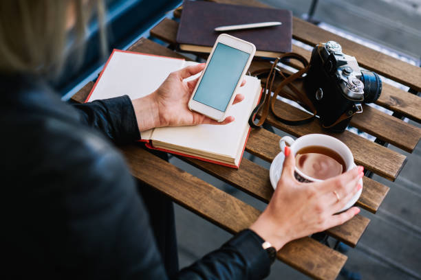 istock Unrecognizable woman using phone in cafe 1465953071