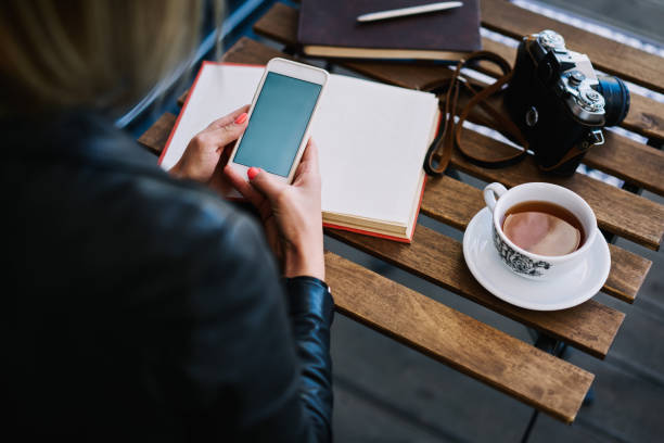 istock Faceless woman using smartphone in cafeteria 1465953106