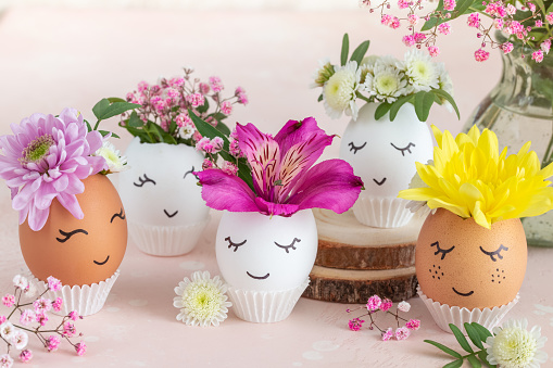 Funny Easter eggs with painted cute face and flowers. Spring  decoration  idea. Creative Easter concept. selective focus