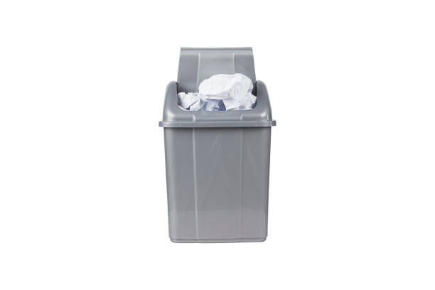 istock gray trash can full of crumpled paper isolate, no background 1465955128