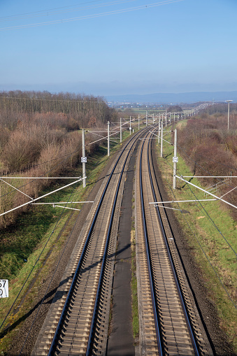 rails with electrification for highspeed train in Germany under blue sky