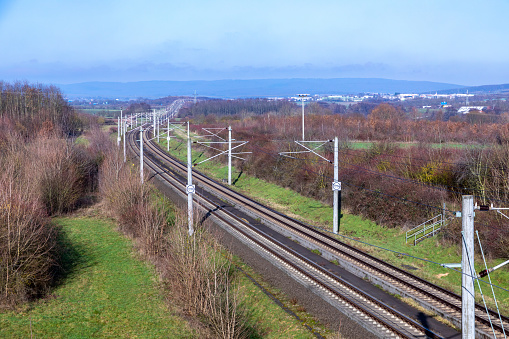 rails with electrification for highspeed train in Germany under blue sky