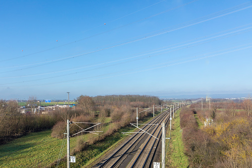 rails with electrification for highspeed train in Germany under blue sky