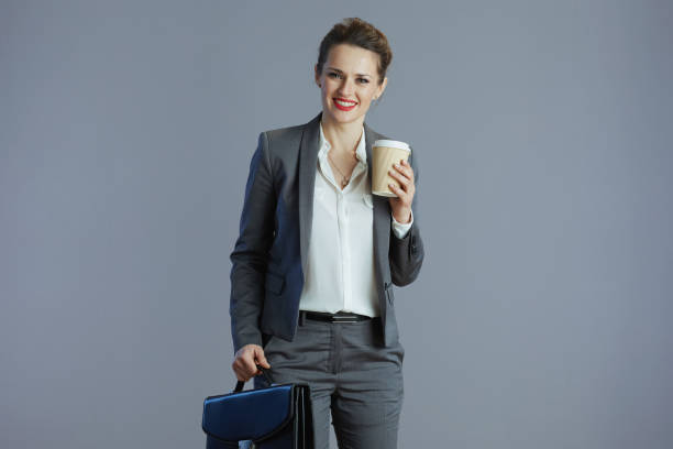 istock smiling young woman worker isolated on gray background 1465960732