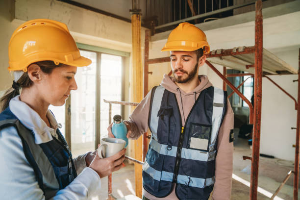istock Blue collar workers are having a coffee break on the construction site 1465963018