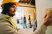 Workers are putting plaster on the wall in the construction site