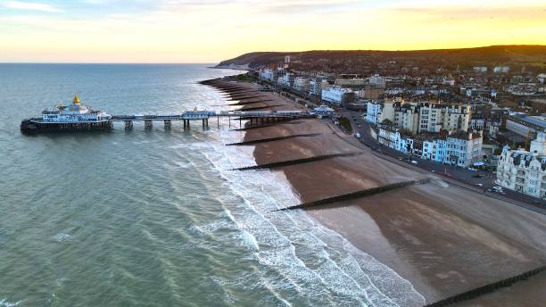 Eastbourne town and  pier at sunset England drone aerial view Eastbourne town and  pier at sunset England drone aerial view eastbourne pier photos stock pictures, royalty-free photos & images