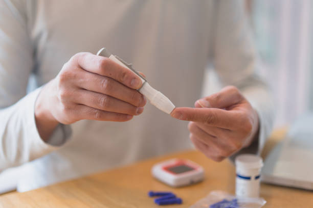 istock young man using blood test kit at home while doing health check . home finger prick blood test . close up, diabetes concept, elderly health care, 1465968991