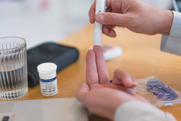 istock young man using blood test kit at home while doing health check . home finger prick blood test . close up, diabetes concept, elderly health care, 1465969079