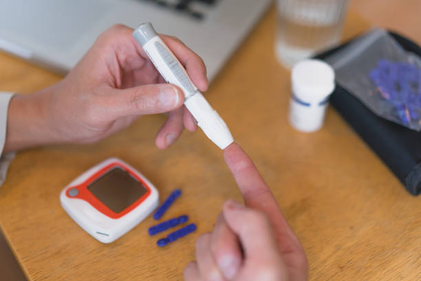 istock young man using blood test kit at home while doing health check . home finger prick blood test . close up, diabetes concept, elderly health care, 1465969121