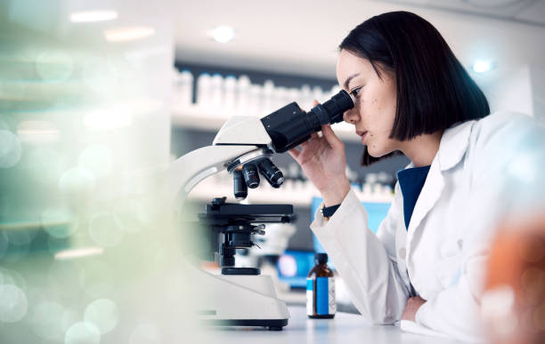 istock Woman, laboratory or doctor with microscope for science data analysis, medical innovation or healthcare research. Scientist, futuristic or female nurse working with medicine, DNA or vaccine data exam 1465969292