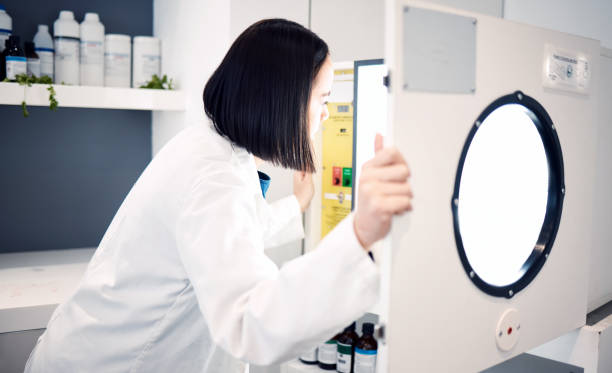 istock Science, woman and scientist in laboratory with incubator, check for experiment, research and scientific innovation. Professional, phd doctor and chemistry, physics or biotechnology study in lab. 1465969367